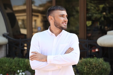 Photo of Portrait of handsome young man on city street