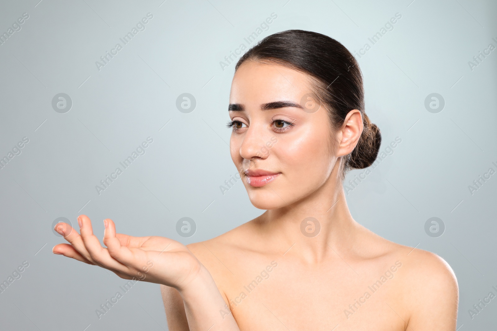 Photo of Portrait of young woman with beautiful face against color background