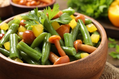 Photo of Bowl of tasty salad with green beans, closeup view