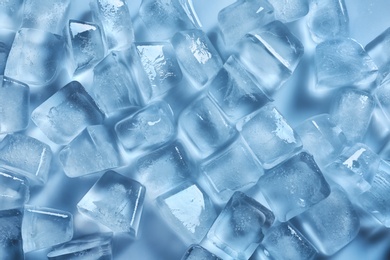 Photo of Many ice cubes on color background, top view