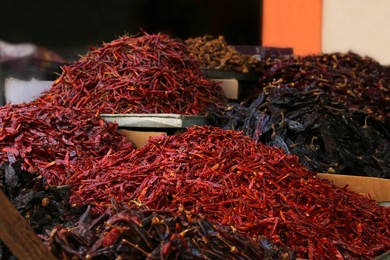 Photo of Heap of dried chili peppers on counter at market