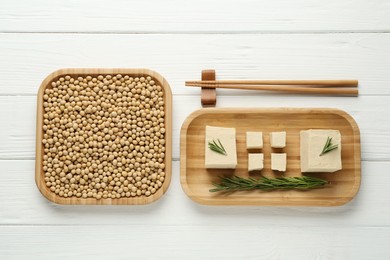 Photo of Pieces of delicious tofu with rosemary and soy on white wooden table, flat lay