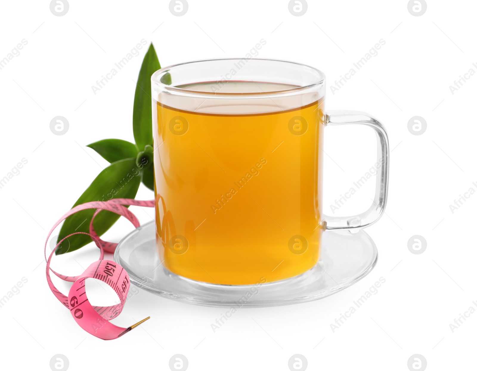 Photo of Glass cup of diet herbal tea, measuring tape \and fresh leaves on white background. Weight loss