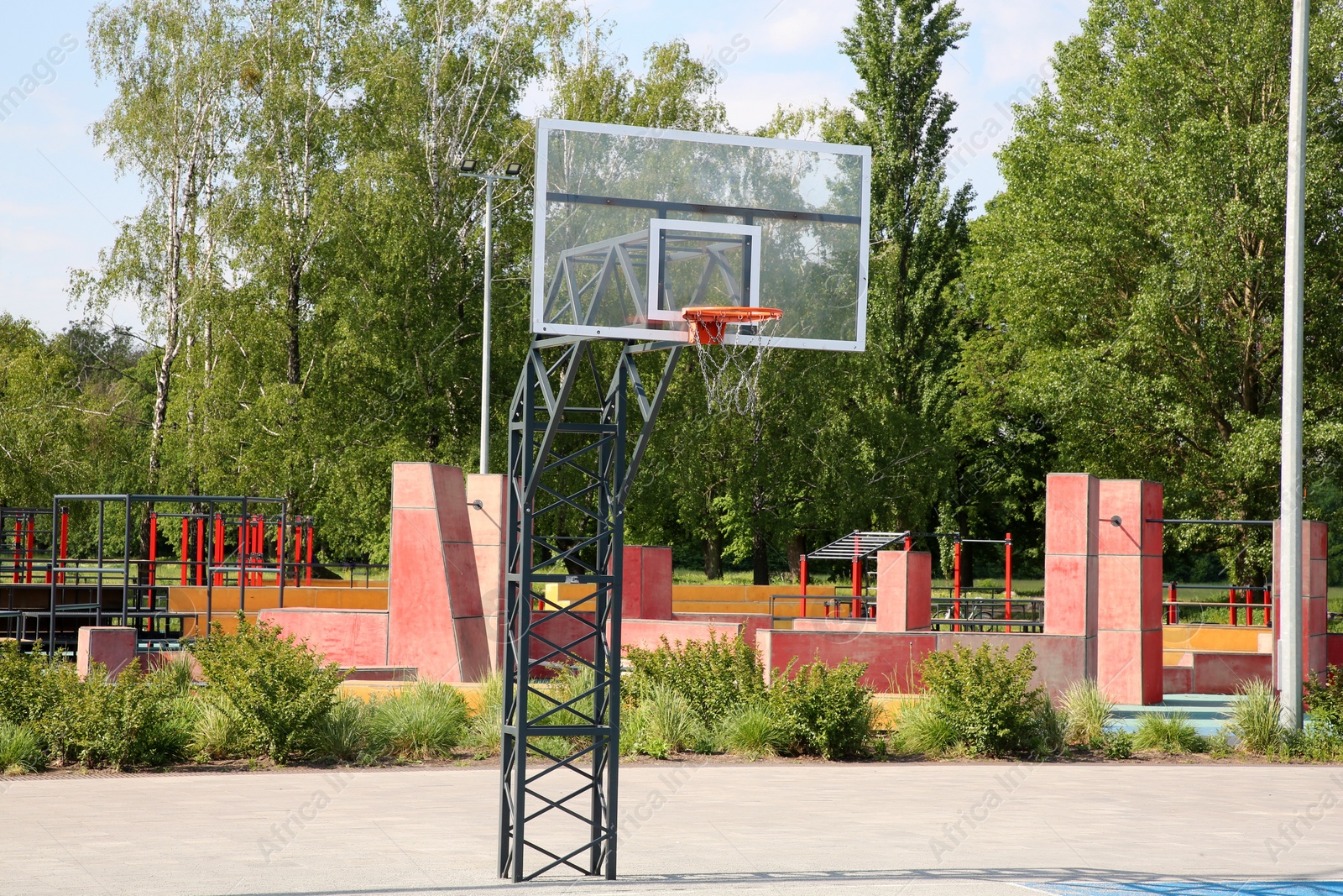 Photo of Empty basketball court with backboard outdoors on sunny day