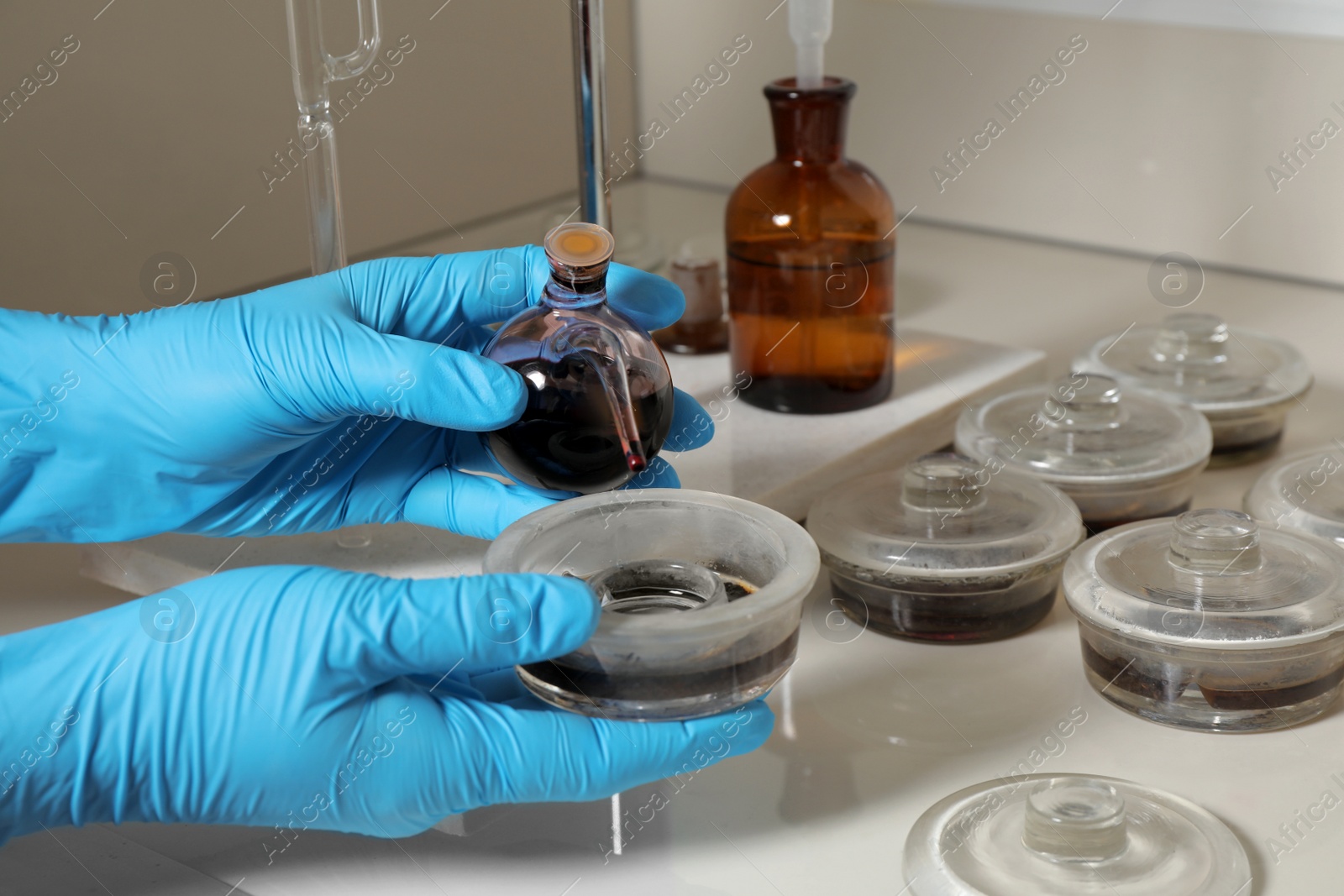 Photo of Scientist doing nitrogen titration of soil sample at table, closeup. Laboratory research