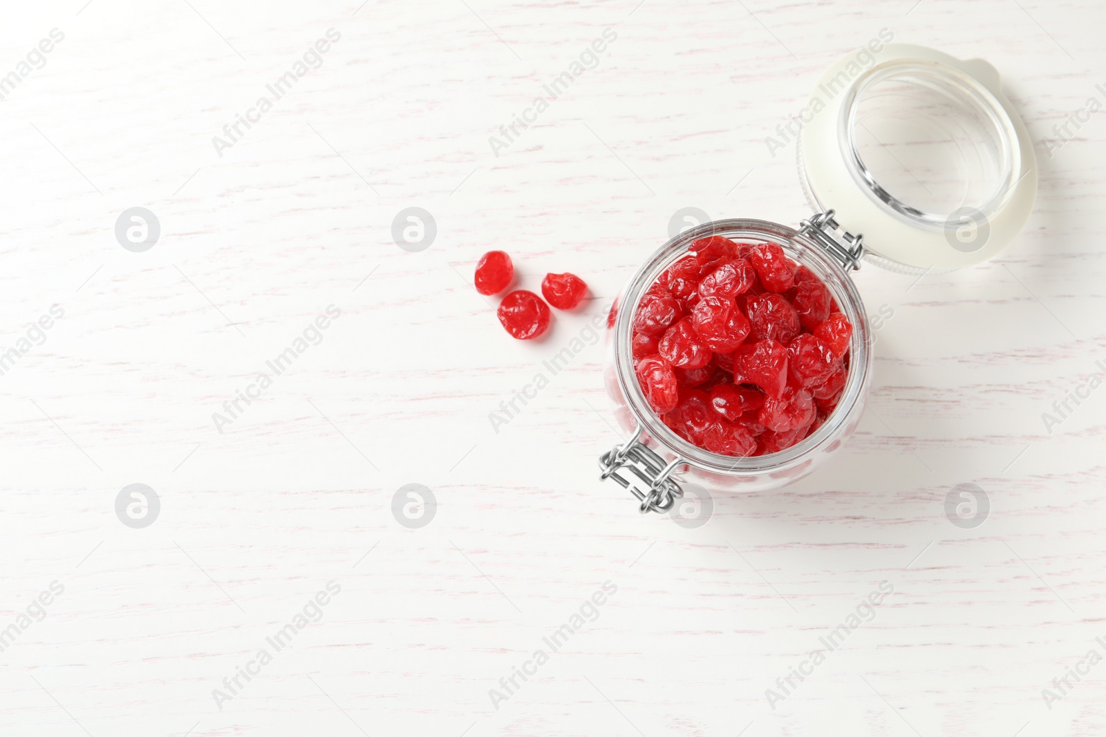 Photo of Jar of tasty cherries on wooden background, top view with space for text. Dried fruits as healthy food