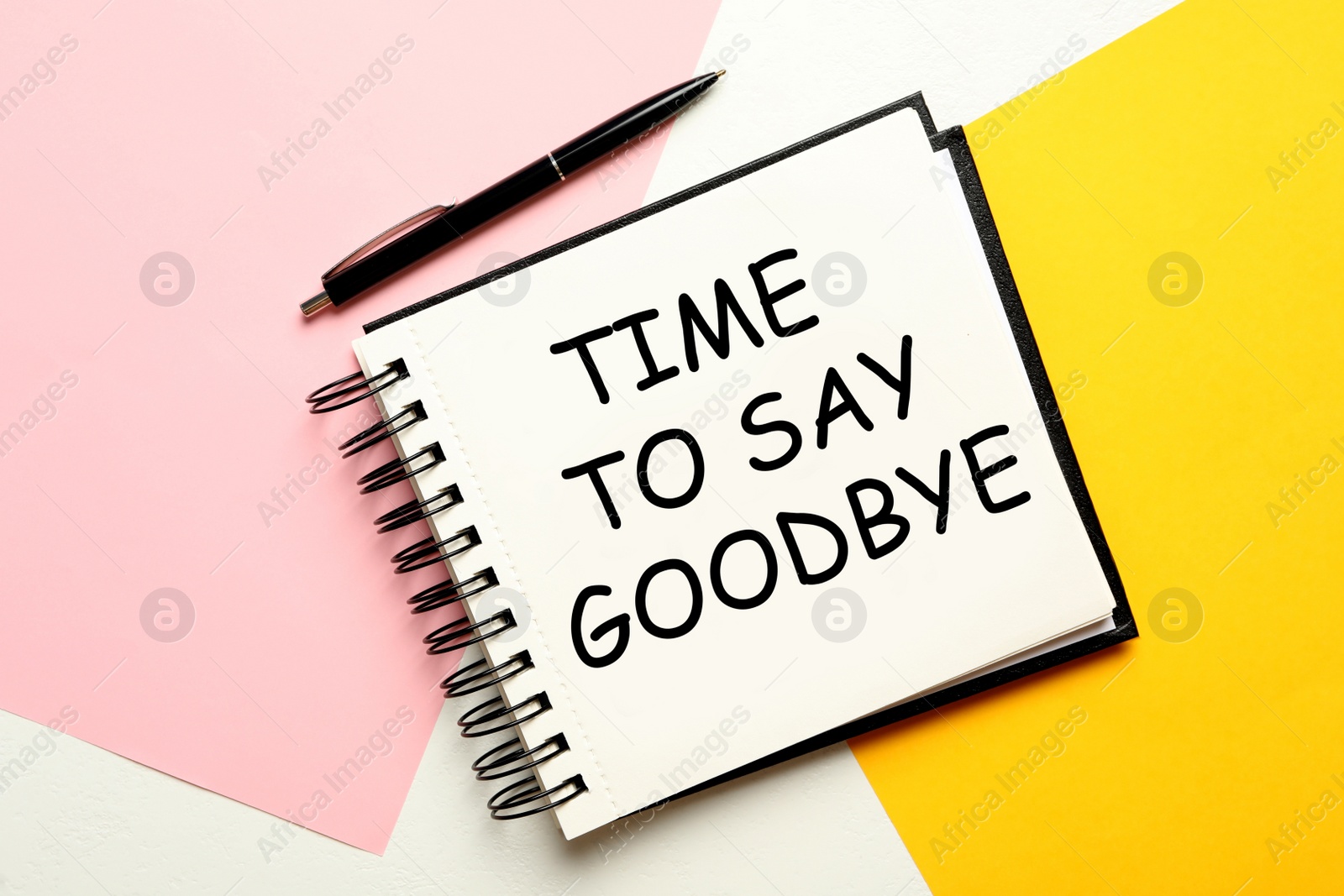 Image of Notebook with text Time to say goodbye on color background, flat lay