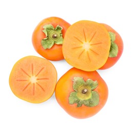 Photo of Whole and cut delicious ripe juicy persimmons on white background, top view