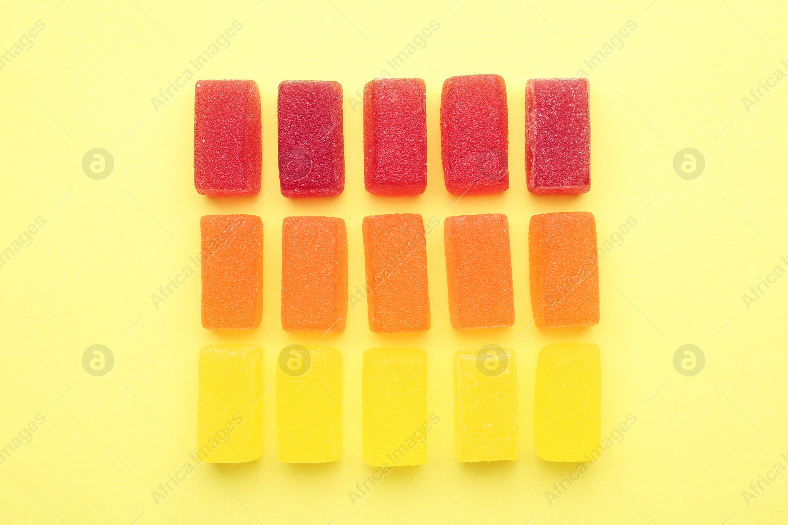 Photo of Tasty jelly candies on color background, flat lay