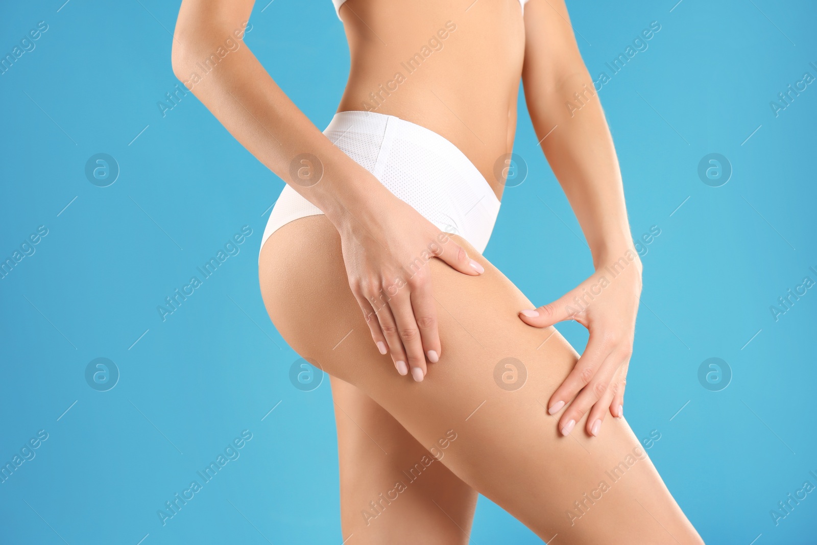 Photo of Closeup view of slim woman in underwear on color background. Cellulite problem concept