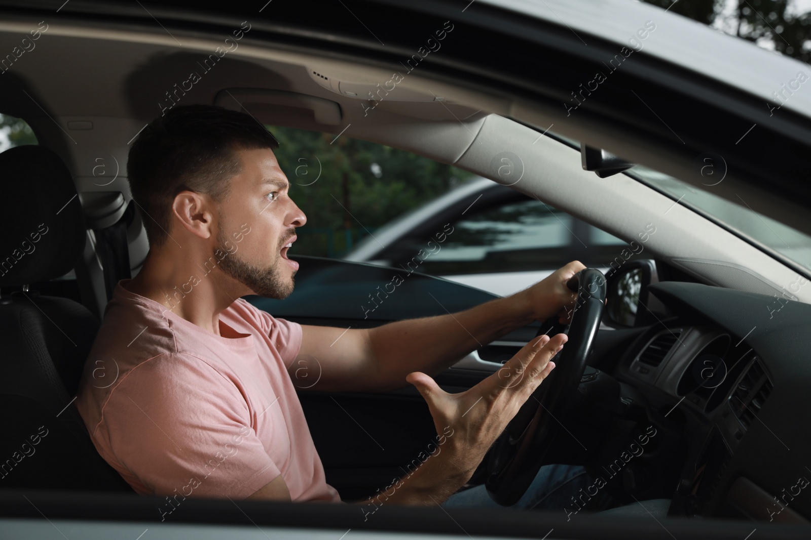 Photo of Stressed man in driver's seat of modern car