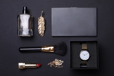 Photo of Flat lay composition with stylish women's accessories on black background