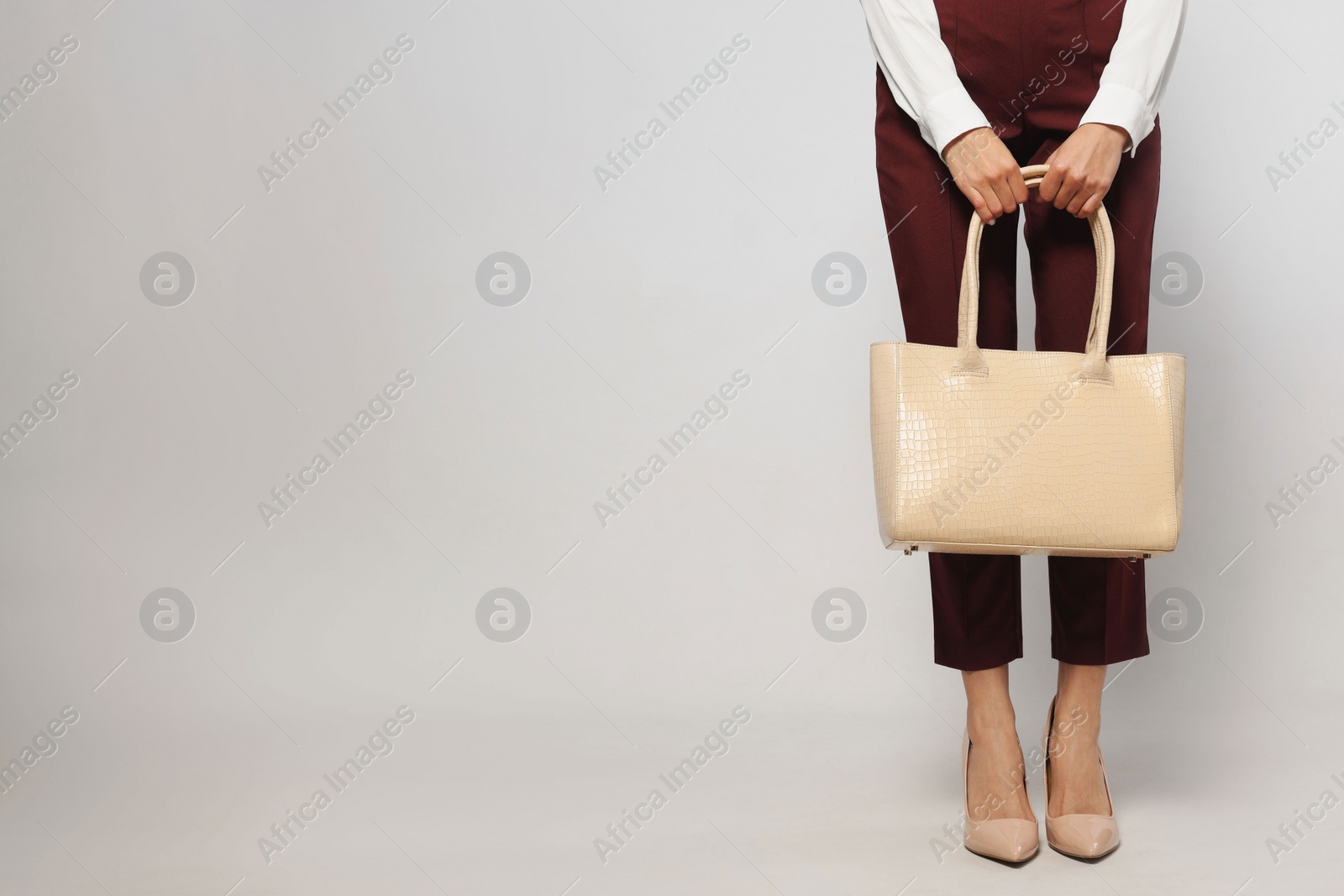 Photo of Young woman with stylish bag on white background, closeup