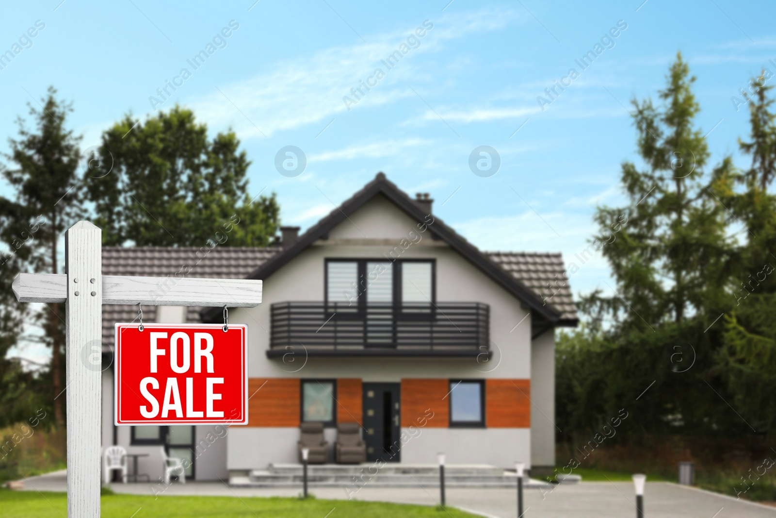 Image of Red sign with words For Sale near new house outdoors. Space for text