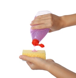 Photo of Woman pouring cleaning product for dish washing onto sponge on white background, closeup