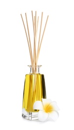 Photo of New reed air freshener and flower on white background
