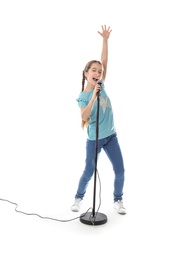 Photo of Cute girl singing in microphone on white background