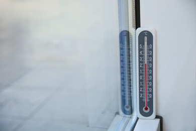 Photo of Weather thermometer near window indoors. Space for text