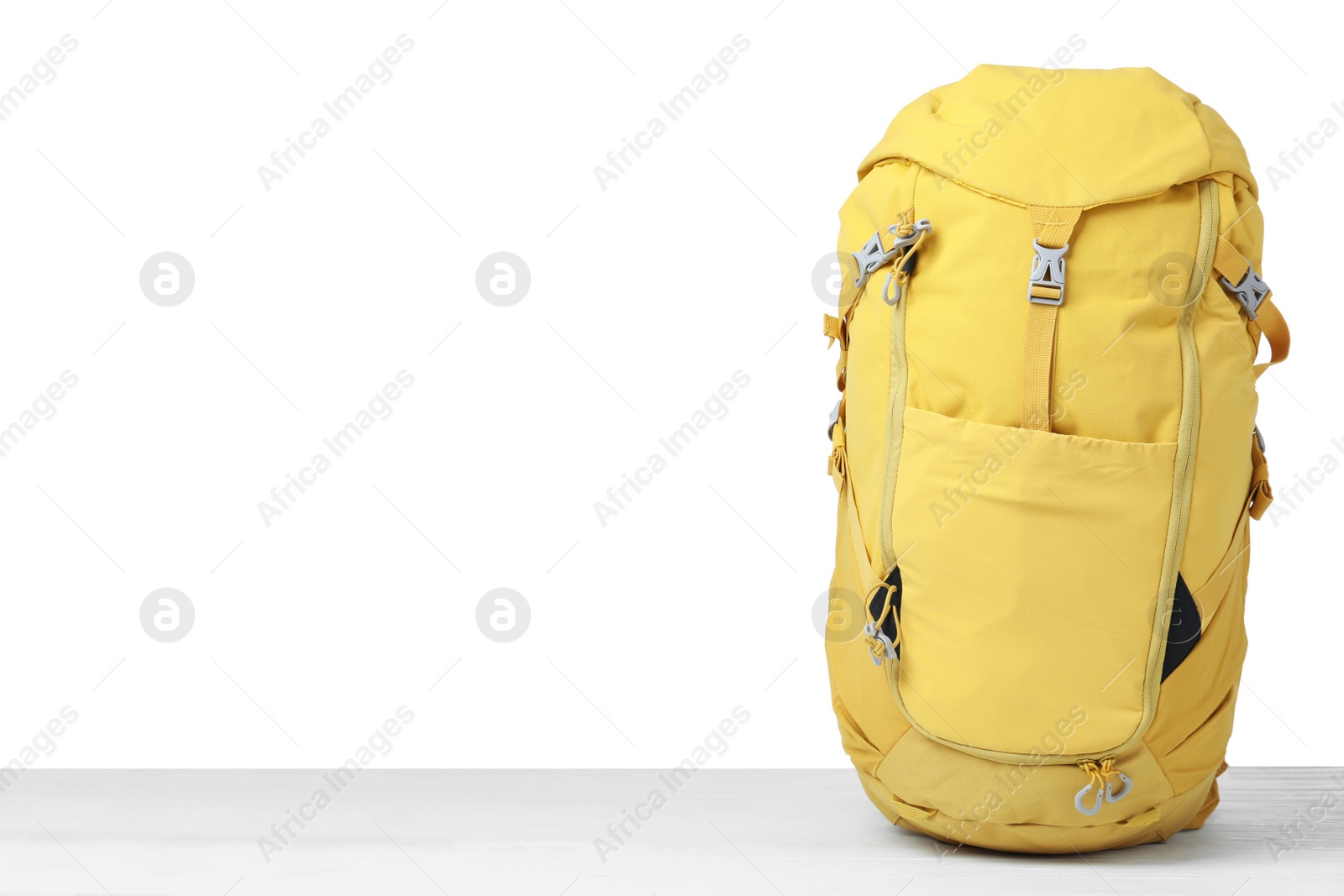 Photo of Hiking backpack on wooden surface against white background. Space for text