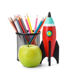 Photo of Bright toy rocket, apple and pencils on white background