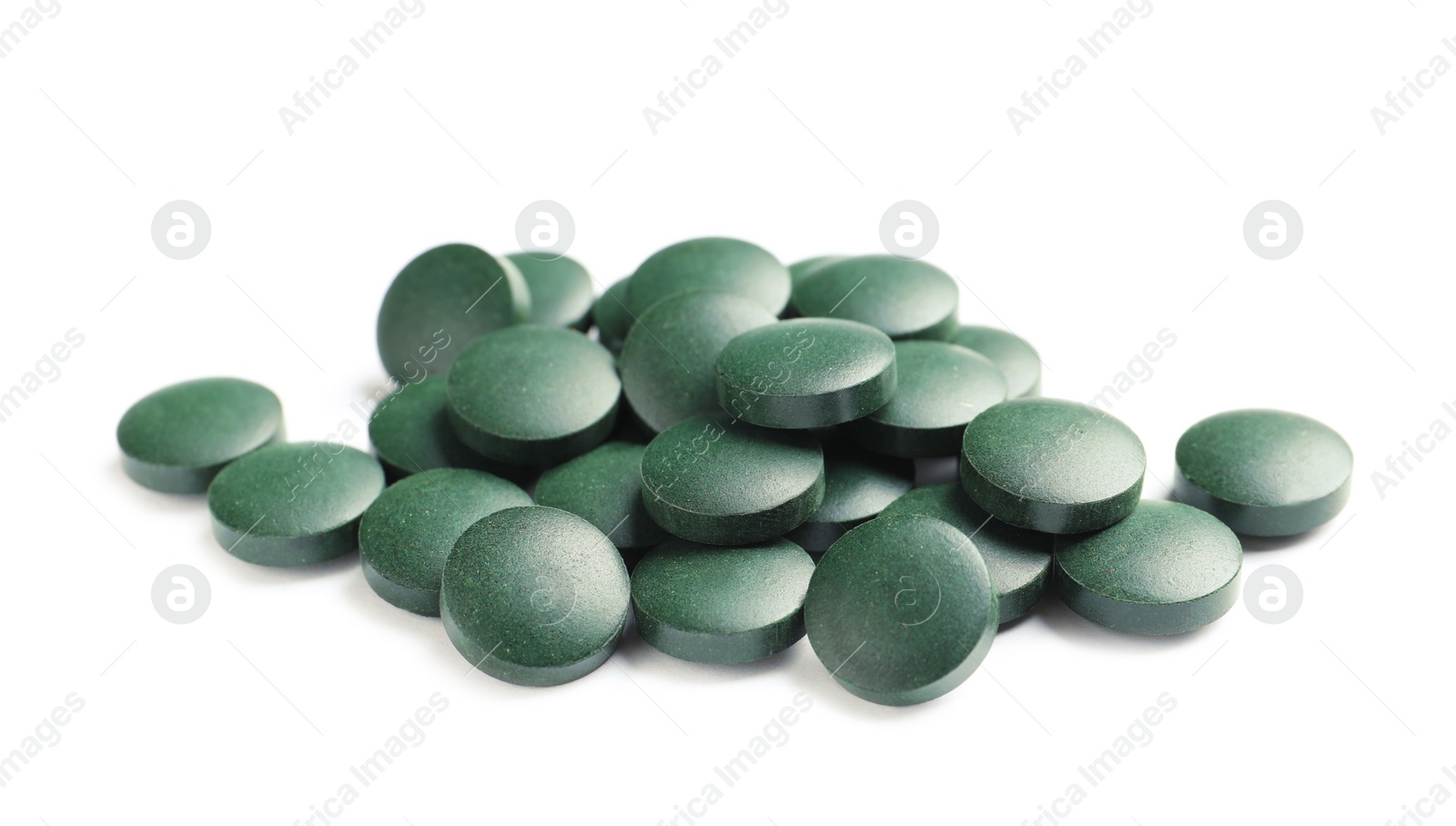 Photo of Heap of spirulina tablets on white background