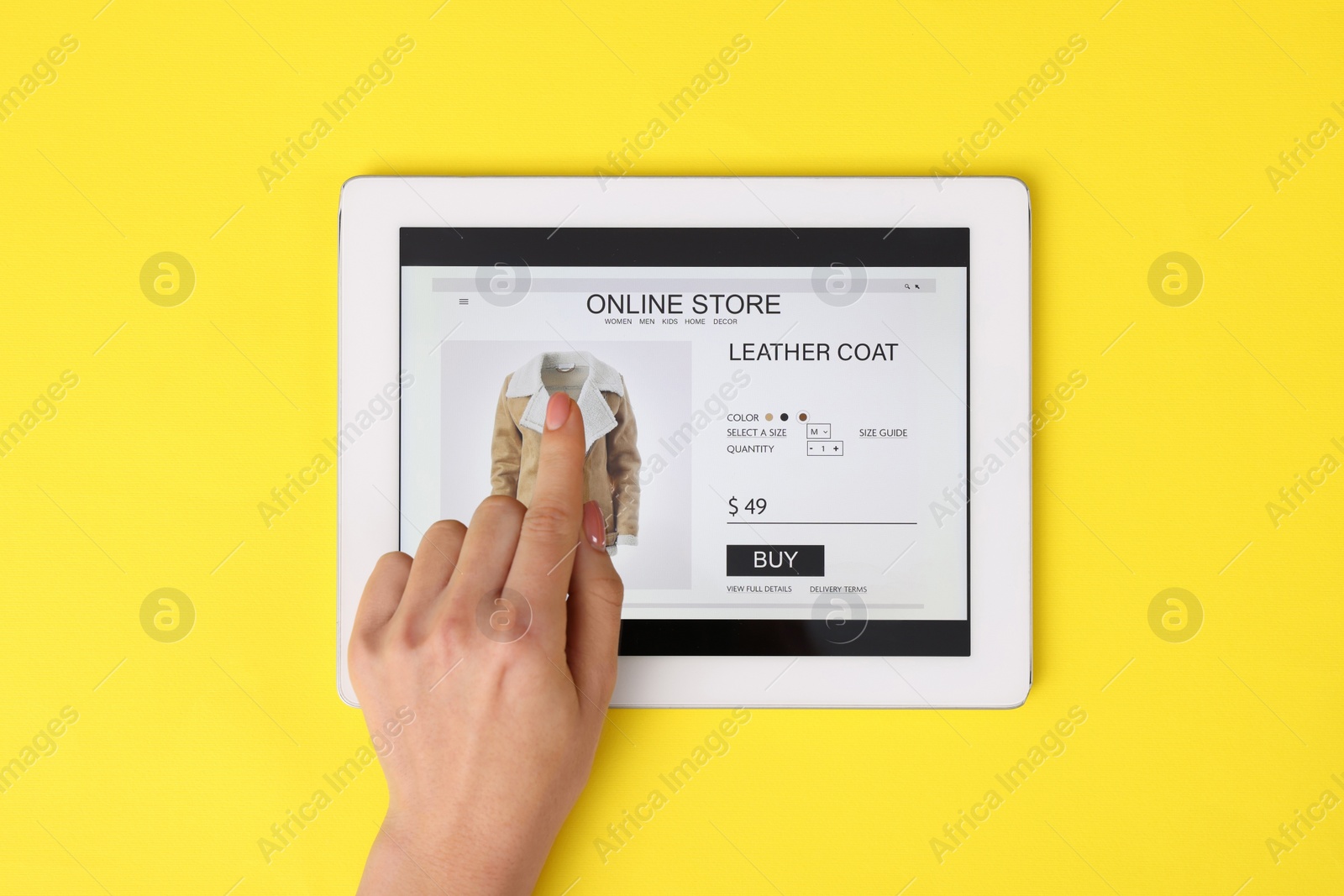 Photo of Woman with tablet shopping online on yellow background, top view