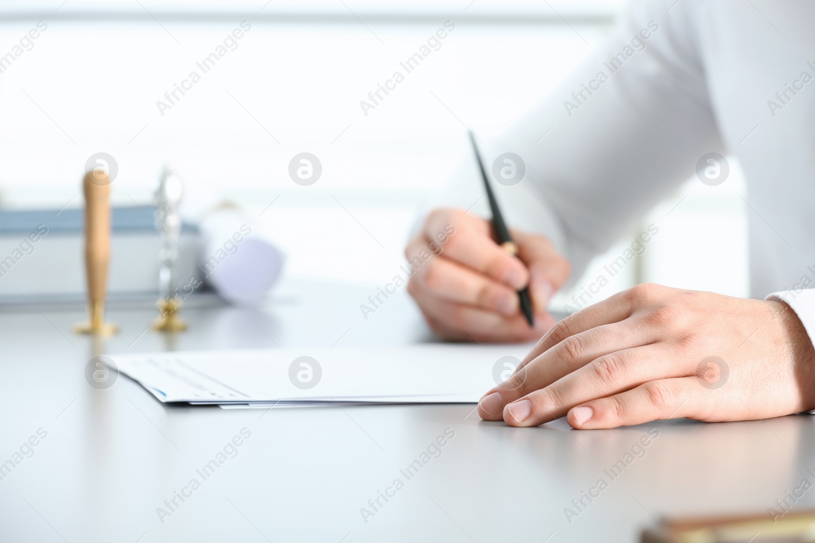 Photo of Male notary working with documents at table, closeup