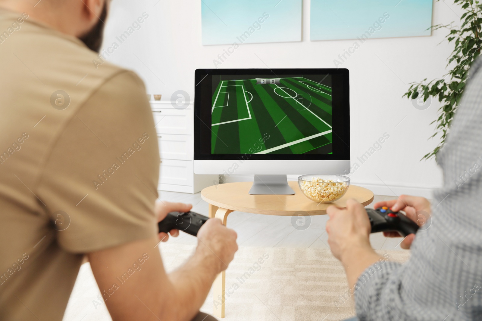 Photo of Friends playing video games at home, closeup