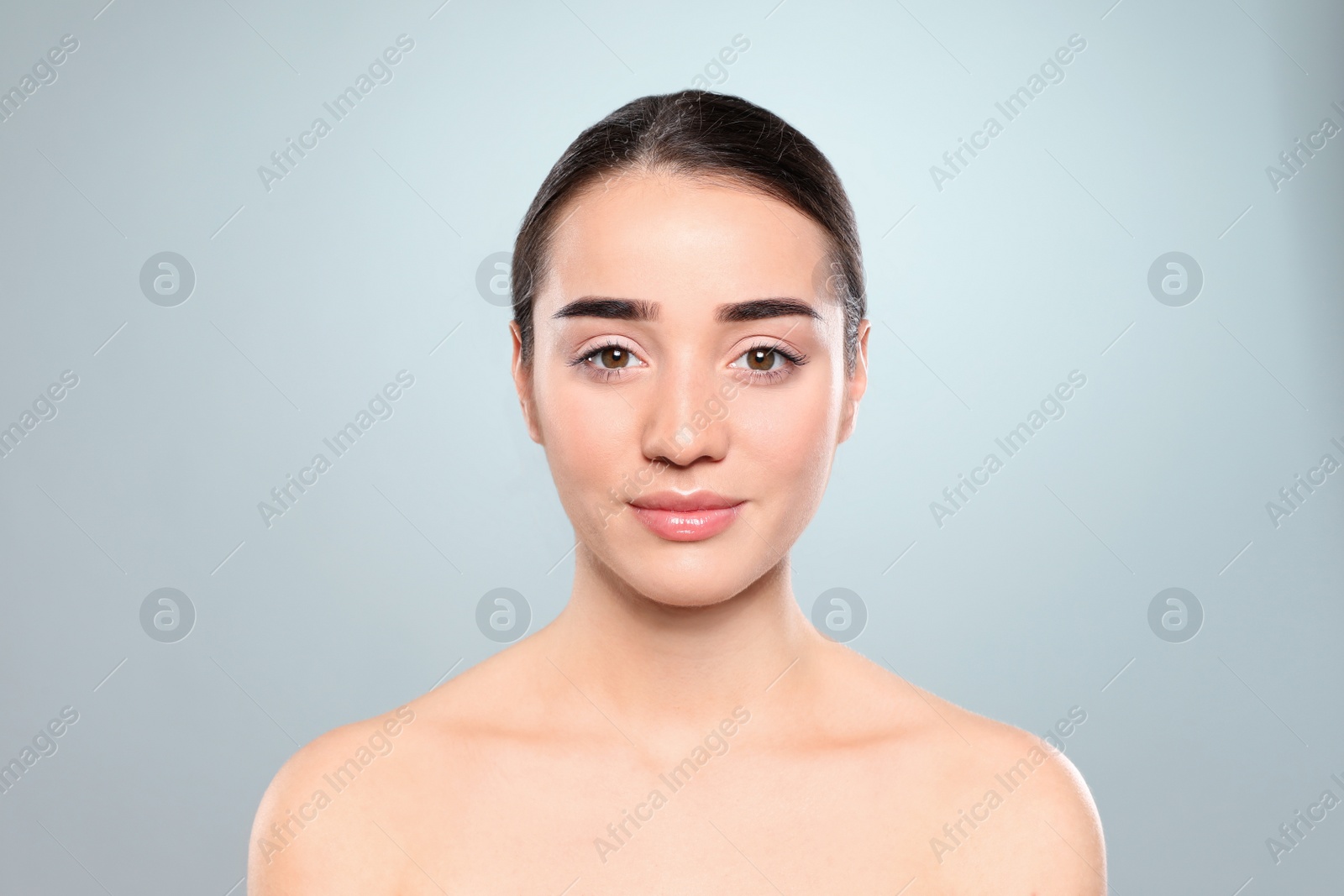 Photo of Portrait of young woman with beautiful face against color background