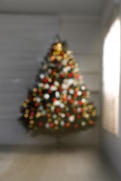 Photo of Blurred view of beautifully decorated Christmas tree indoors. Bokeh effect