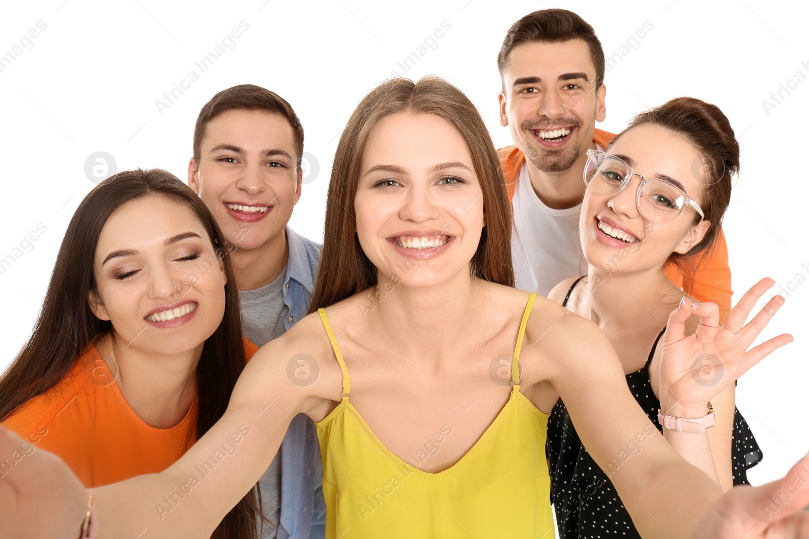 Photo of Young happy friends taking selfie against white background