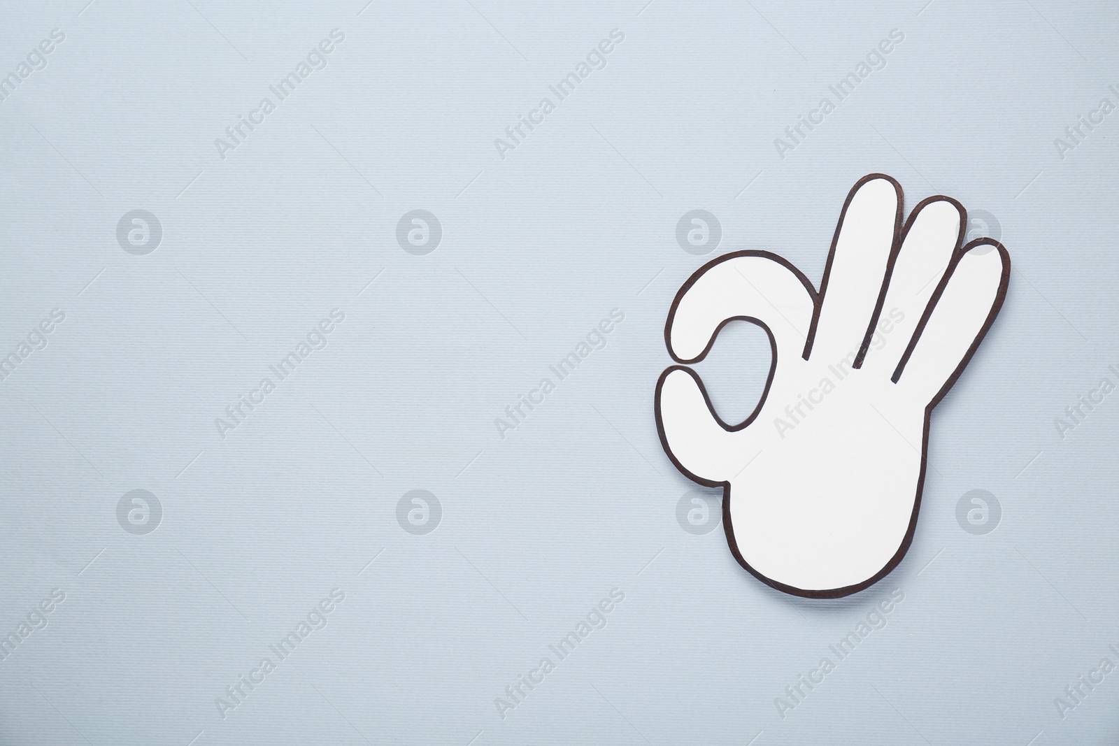 Photo of Paper cutout of okay hand gesture on light grey background, top view. Space for text