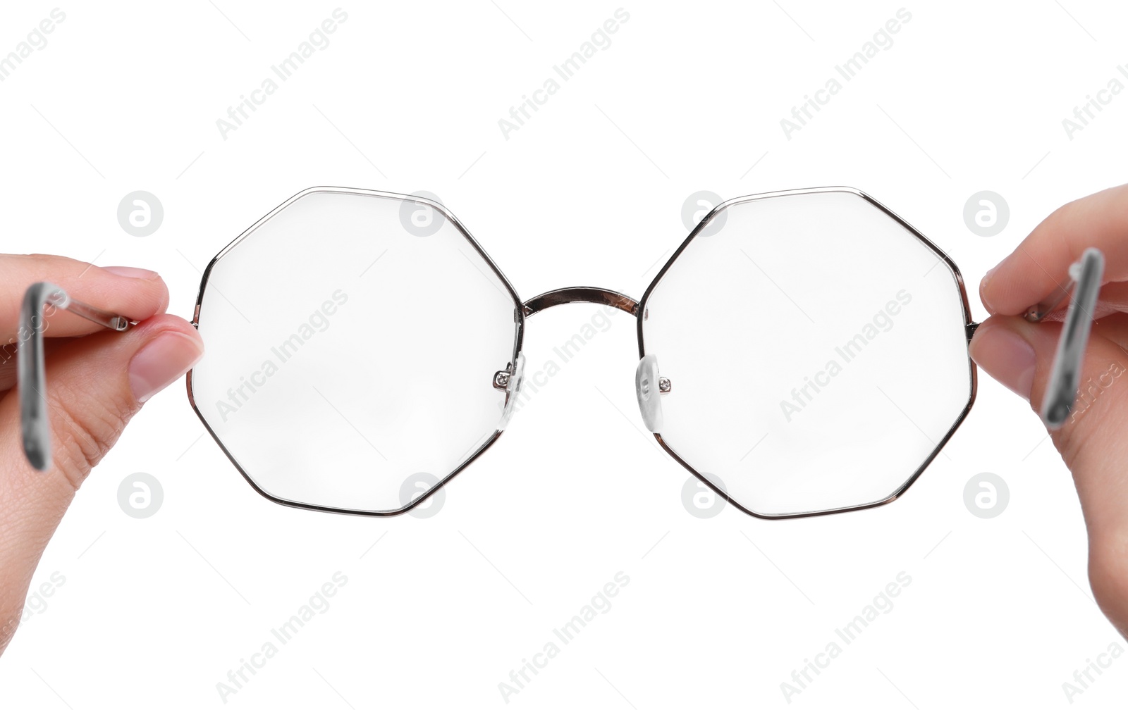 Photo of Woman holding stylish glasses with metal frame on white background, closeup