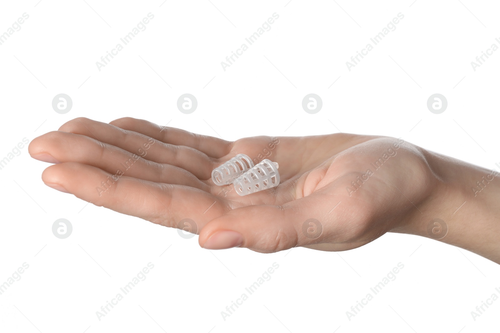 Photo of Woman holding anti-snoring device for nose on white background, closeup