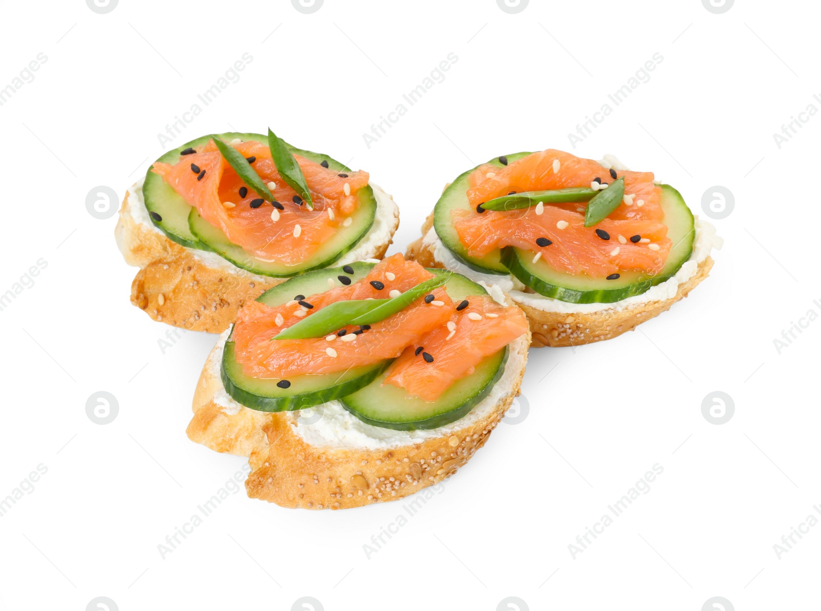 Photo of Tasty canapes with salmon, cucumber and cream cheese isolated on white