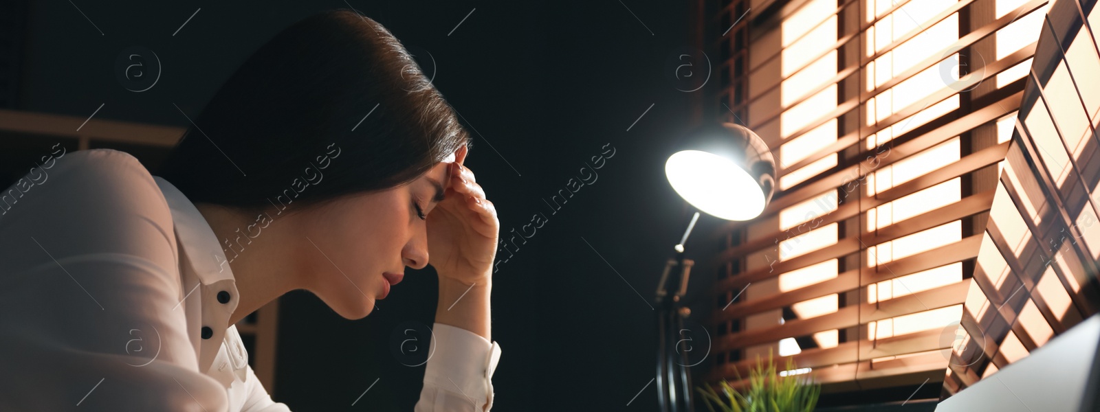 Image of Tired businesswoman stressing out at workplace late in evening. Banner design