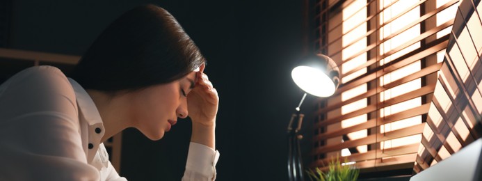 Image of Tired businesswoman stressing out at workplace late in evening. Banner design