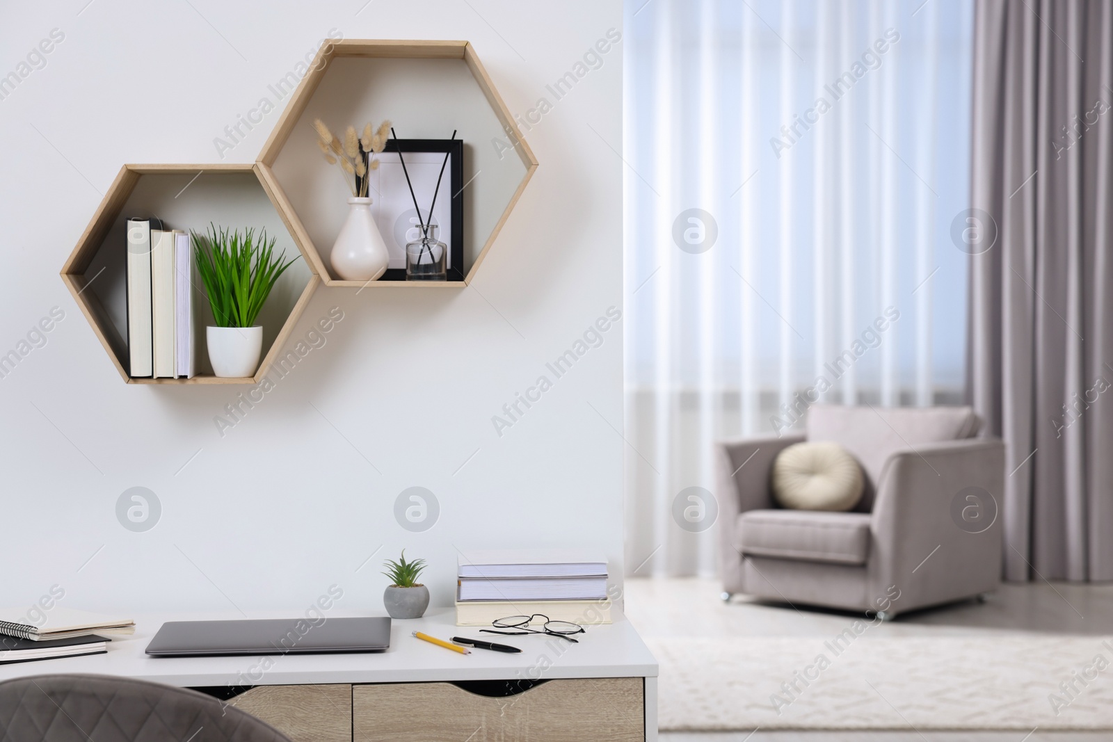 Photo of Home workspace. Laptop and stationery on wooden desk indoors