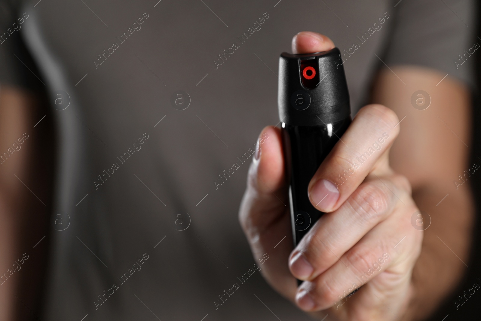 Photo of Man using pepper spray, closeup. Space for text