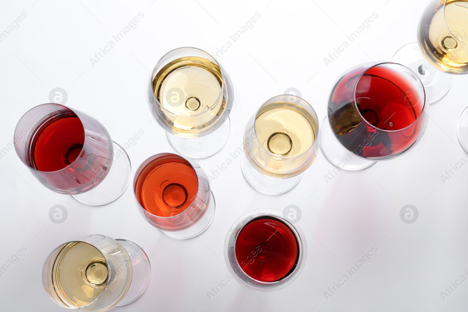 Photo of Different glasses with wine on white background, top view