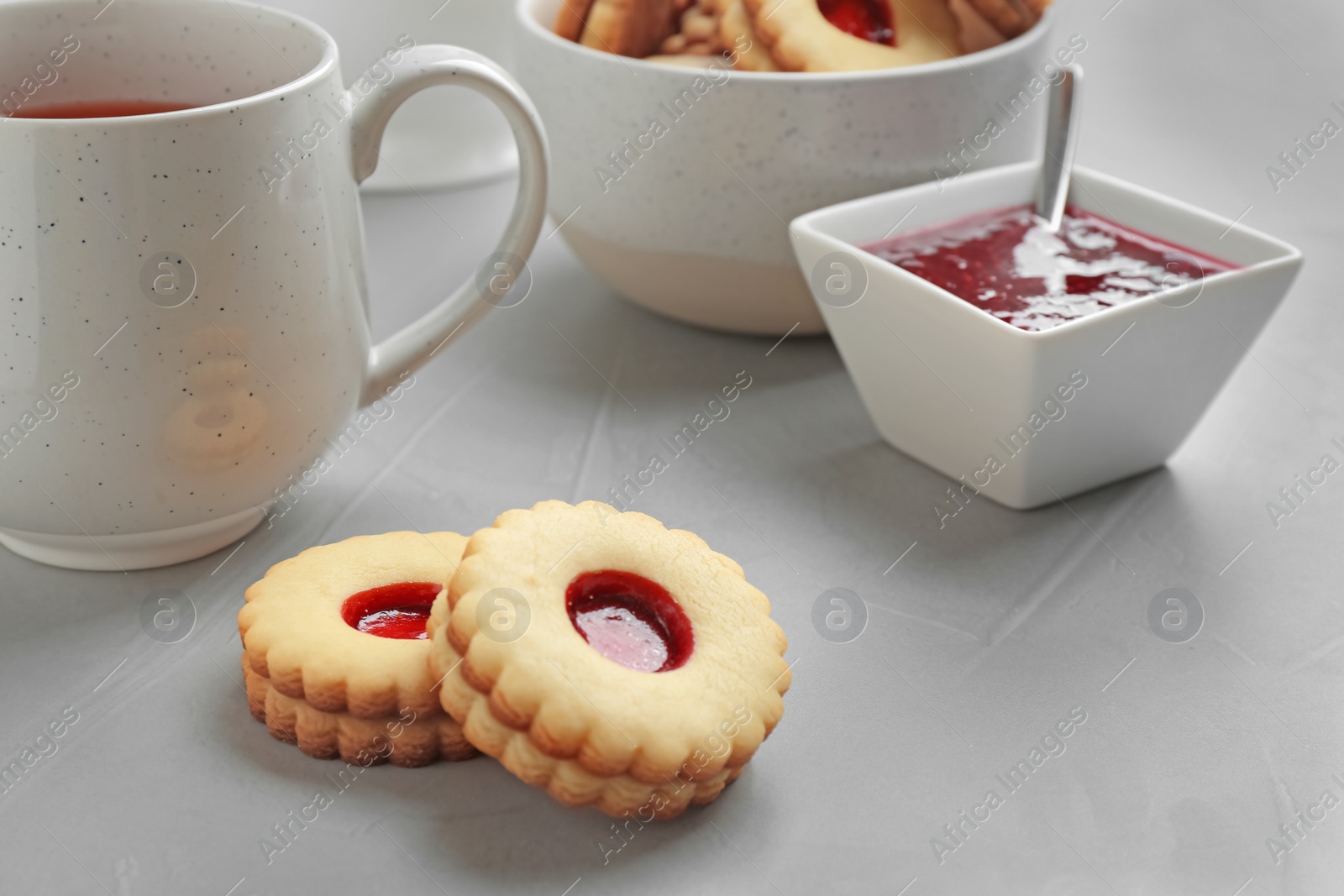 Photo of Traditional Christmas Linzer cookies with sweet jam on table