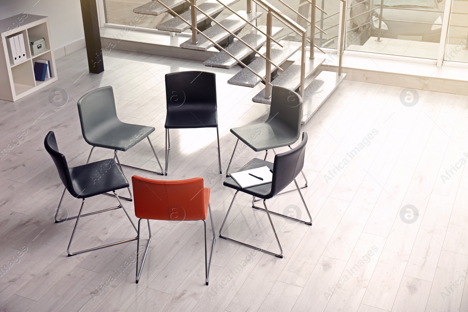 Photo of Chairs prepared for group therapy session in office. Meeting room interior