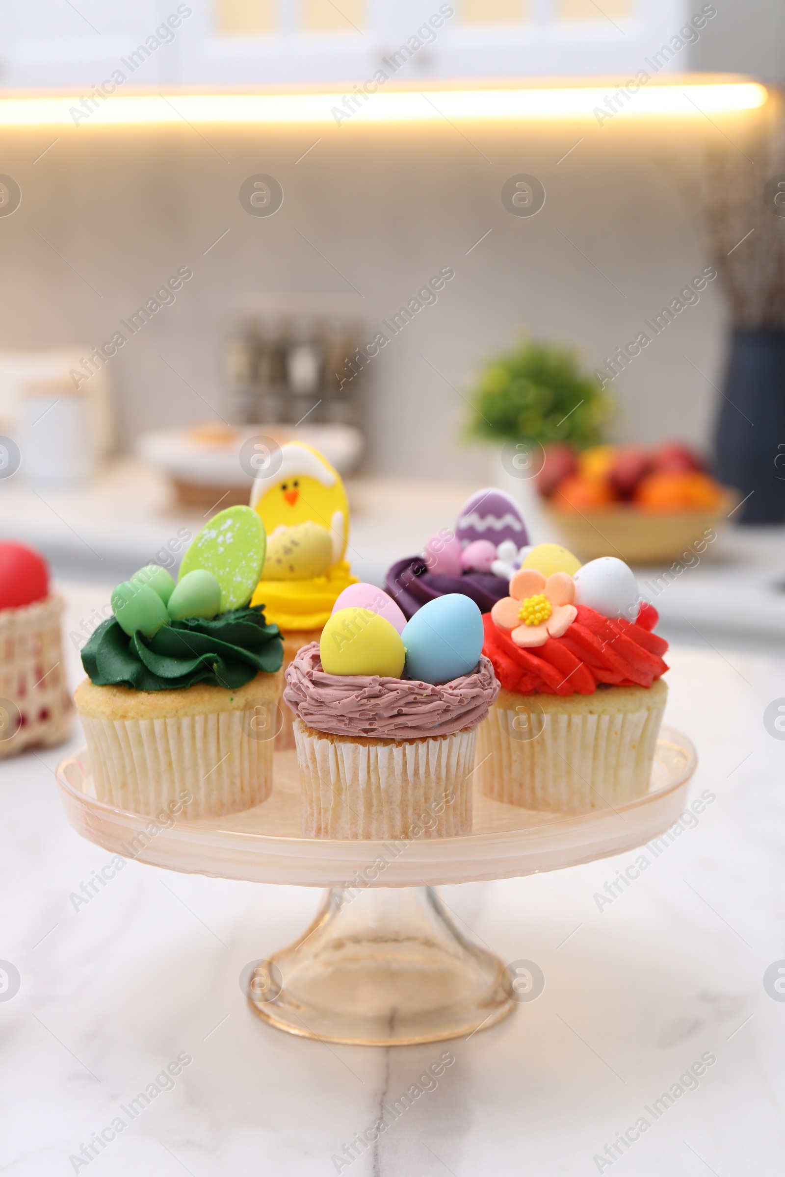 Photo of Tasty decorated Easter cupcakes on white marble table