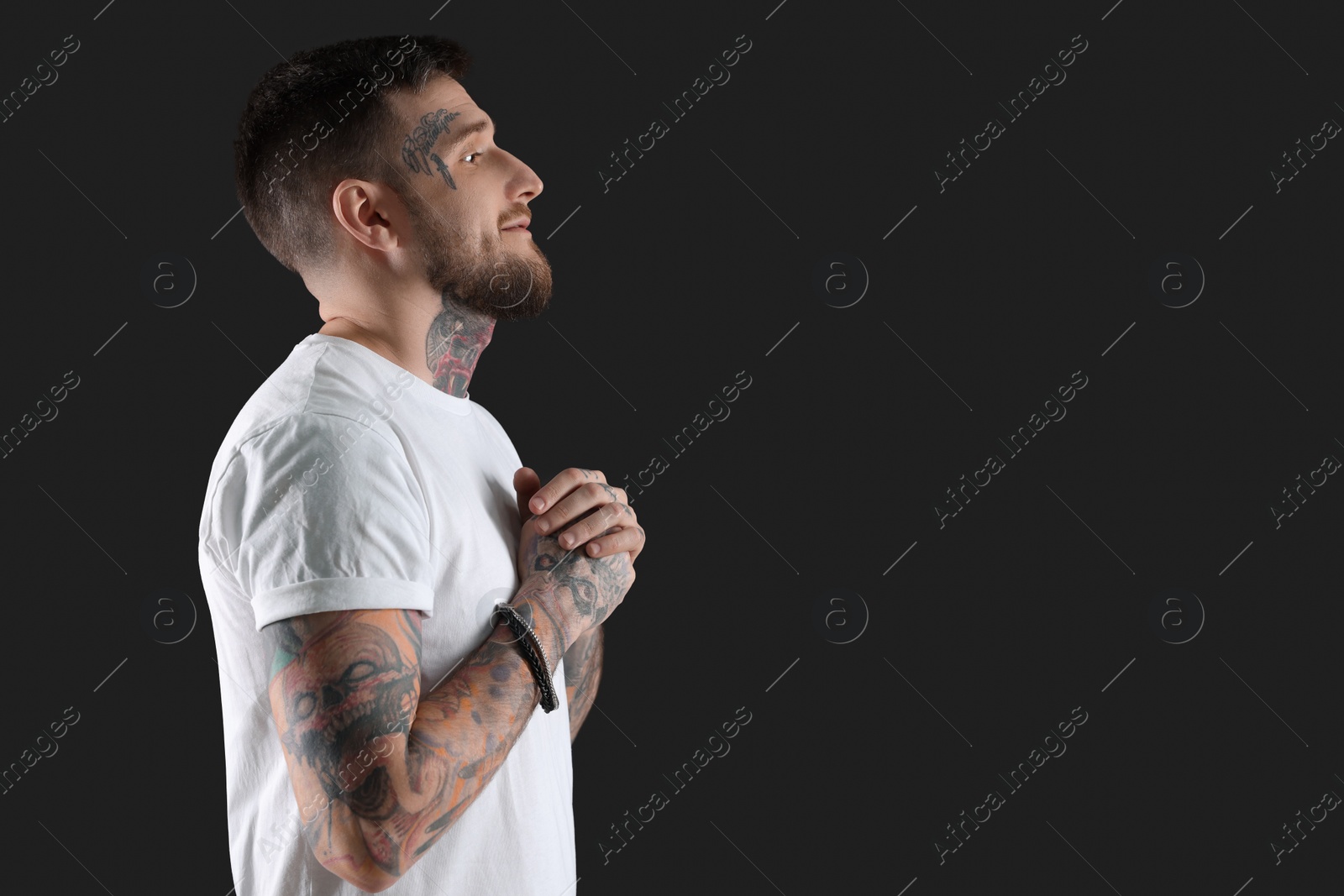 Photo of Handsome hipster man on black background. Space for text