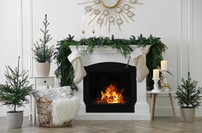 Photo of Stylish room interior with fireplace and beautiful Christmas decor