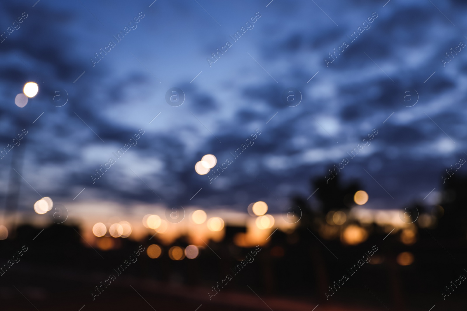 Photo of Blurred view of modern city at evening. Bokeh effect