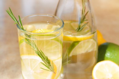 Photo of Summer refreshing lemonade drink on light table, closeup
