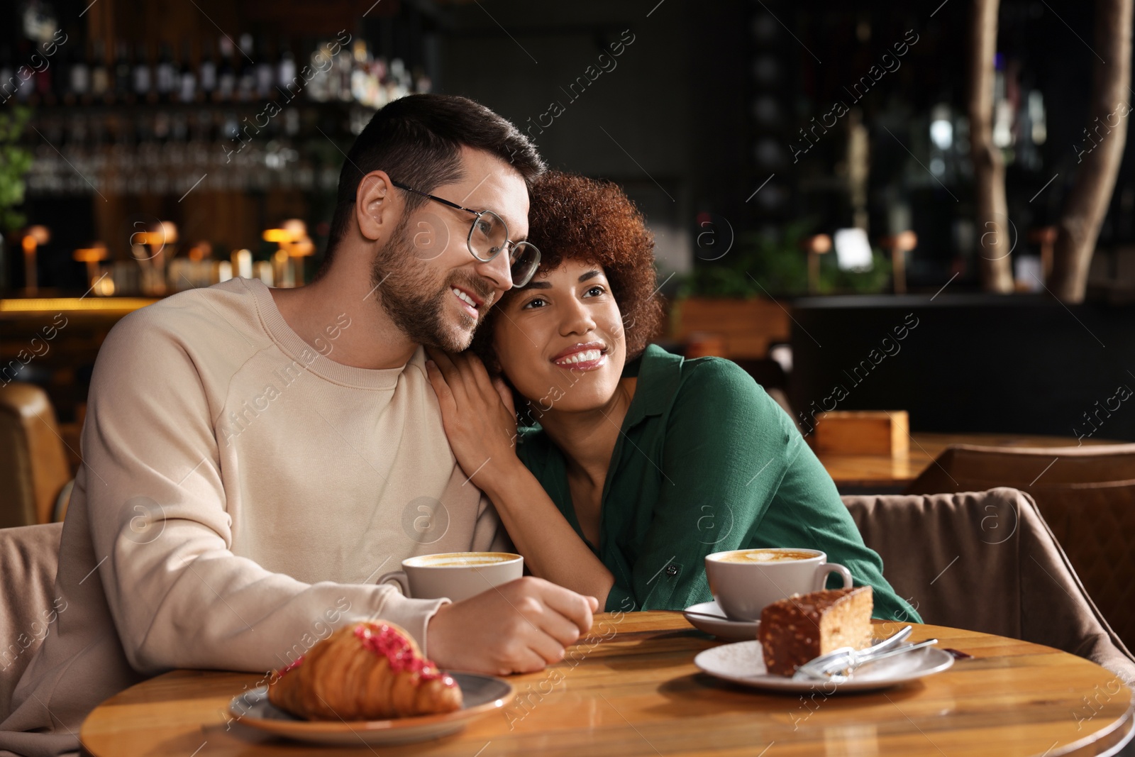 Photo of International dating. Lovely couple spending time together in cafe