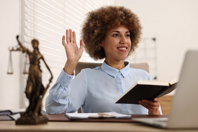 Happy notary with notebook greeting someone in office