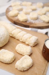 Making lazy dumplings. Raw dough and flour on table, closeup